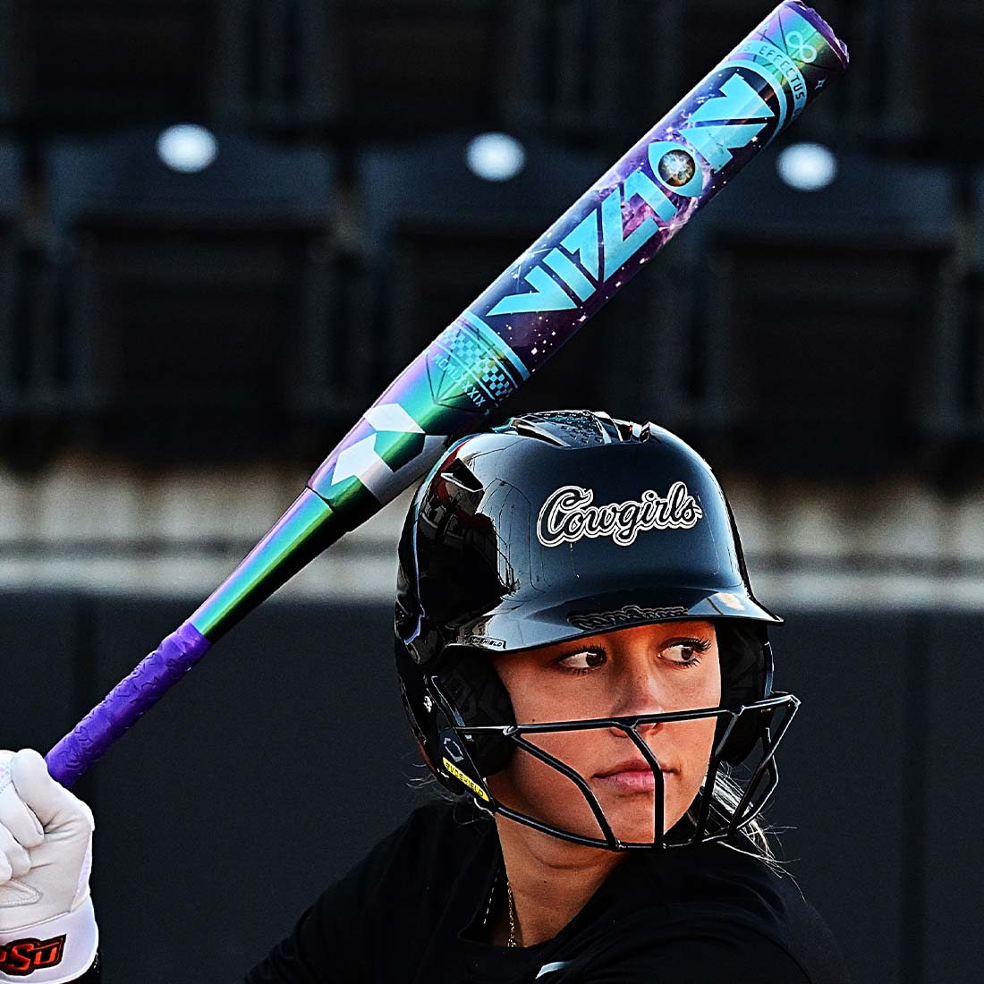 2027 DeMarini Vizion Fastpitch Softball Bat on the field held by a College Softball Player