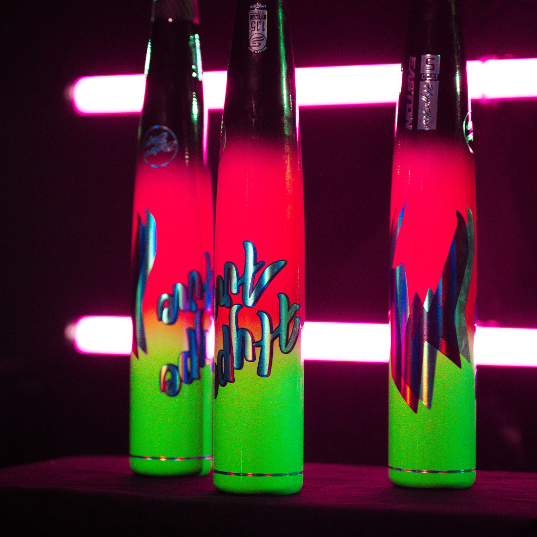 Hype Fire USSSA Family Picture Showing the Colors of the bats in Neon Lighting