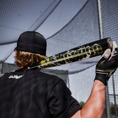 A Baseball player holding up the 2027 Voodoo One BBCOR Baseball Bat