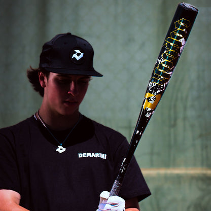 A Baseball Player holding the 2027 DeMarini Voodoo One BBCOR (-3) Baseball Bat in a cage