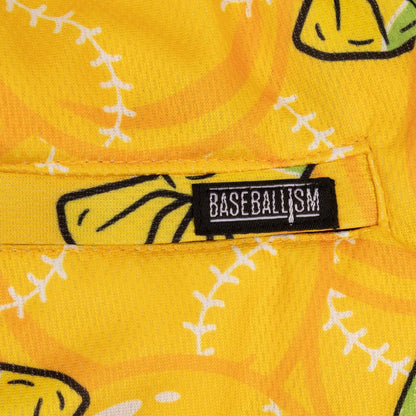 A pair of yellow athletic mesh shorts with a pattern of bubbles and text, and a drawstring waist.