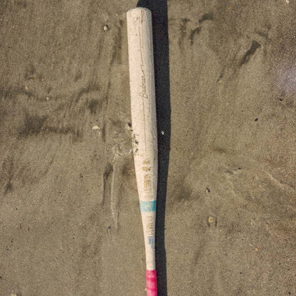A Combat  Coastal Bradley Jones bat laying on the beach in the sun