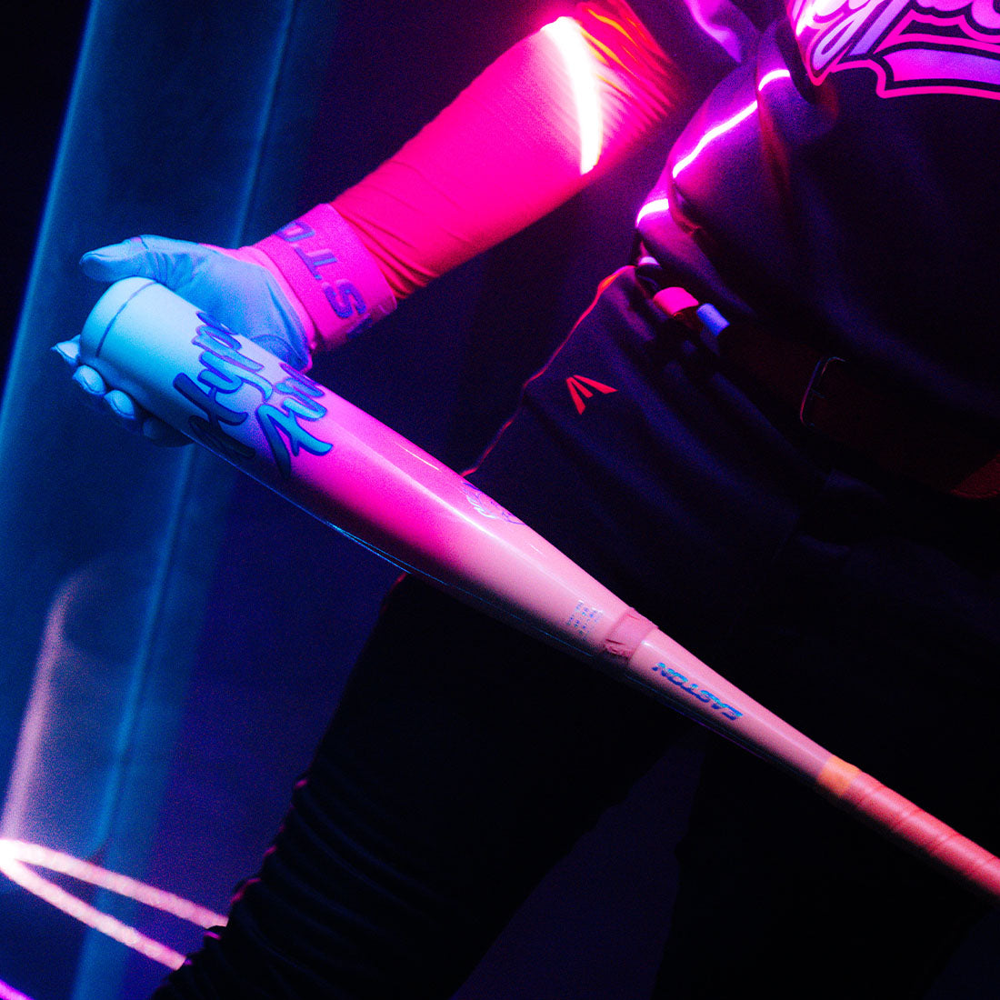 A Baseball Player holding the 2027 Easton Hype Fire 2 5/8" USA Baseball Bat in Neon Lighting
