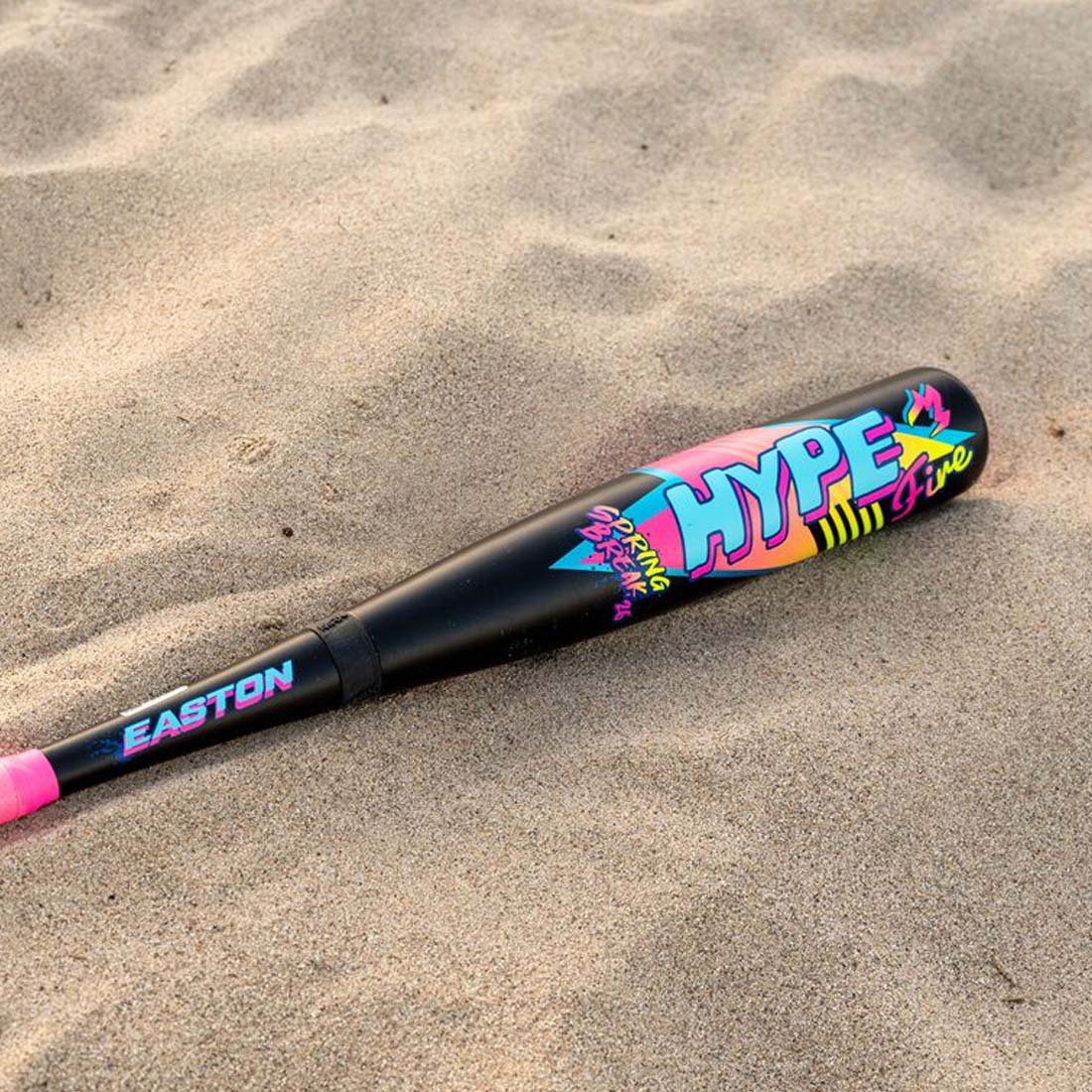 2026 Easton Hype Fire "Spring Break" Black 2 5/8" USA Baseball Bat laying in sand at the beach