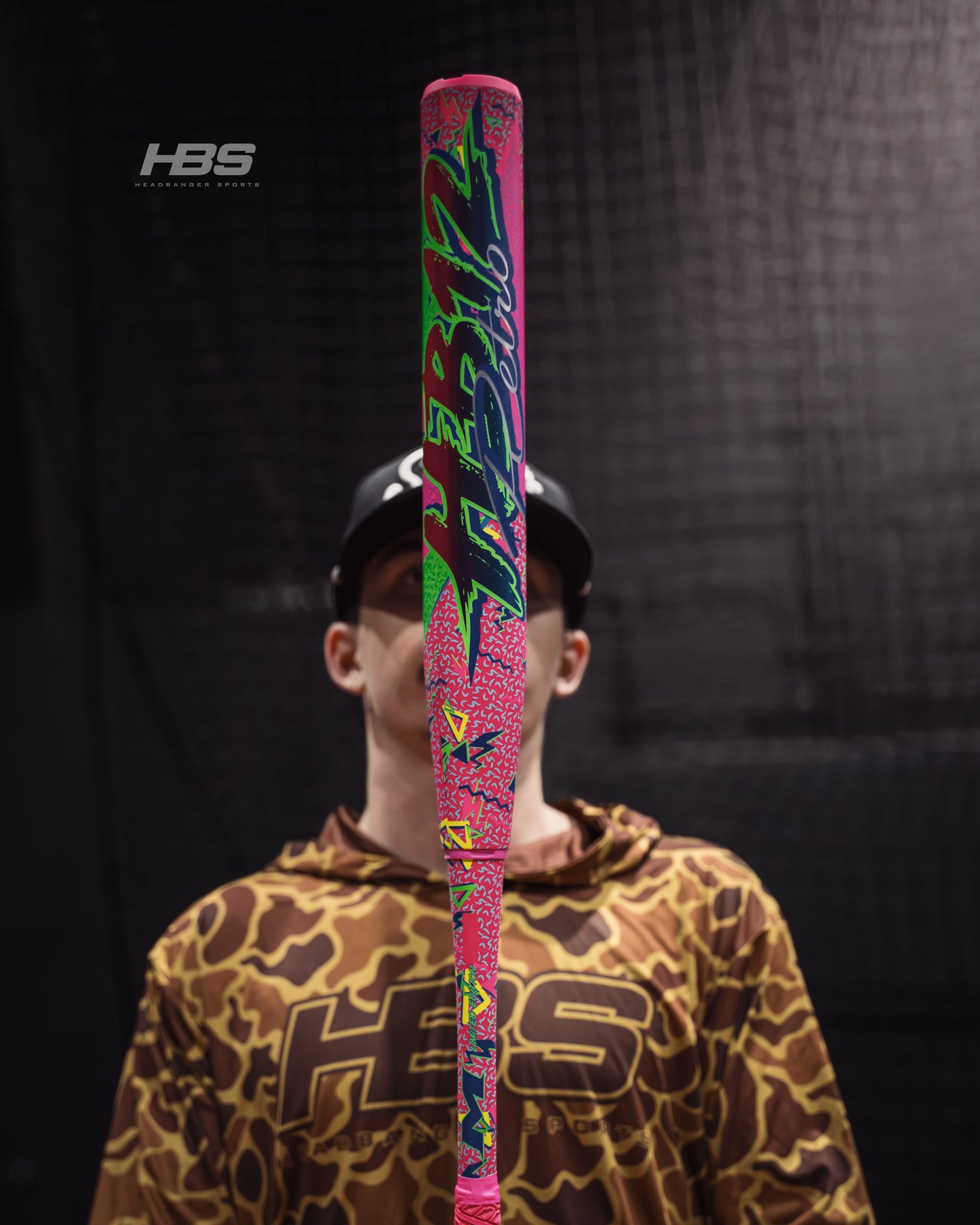 Softball player holding the 2026 Miken HB12 Retro 12.5" End Loaded USA / ASA Slowpitch Softball Bat in the batting cages at Headbanger Sports.