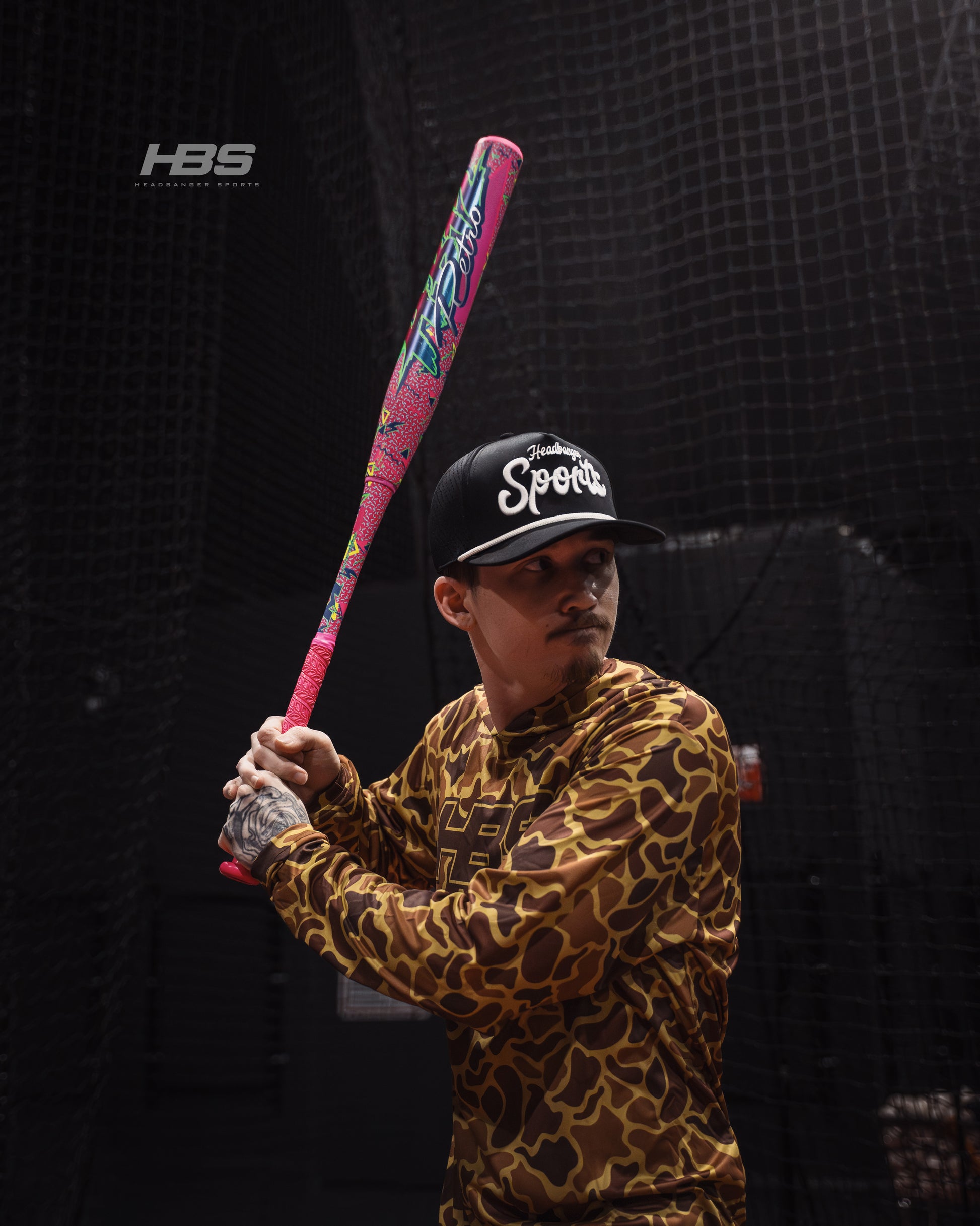 Softball player holding the 2026 Miken HB12 Retro 12.5" End Loaded USA / ASA Slowpitch Softball Bat in the batting cages at Headbanger Sports.