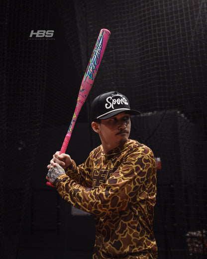 Softball player holding the 2026 Miken HB12 Retro 12.5" End Loaded USA / ASA Slowpitch Softball Bat in the batting cages at Headbanger Sports.