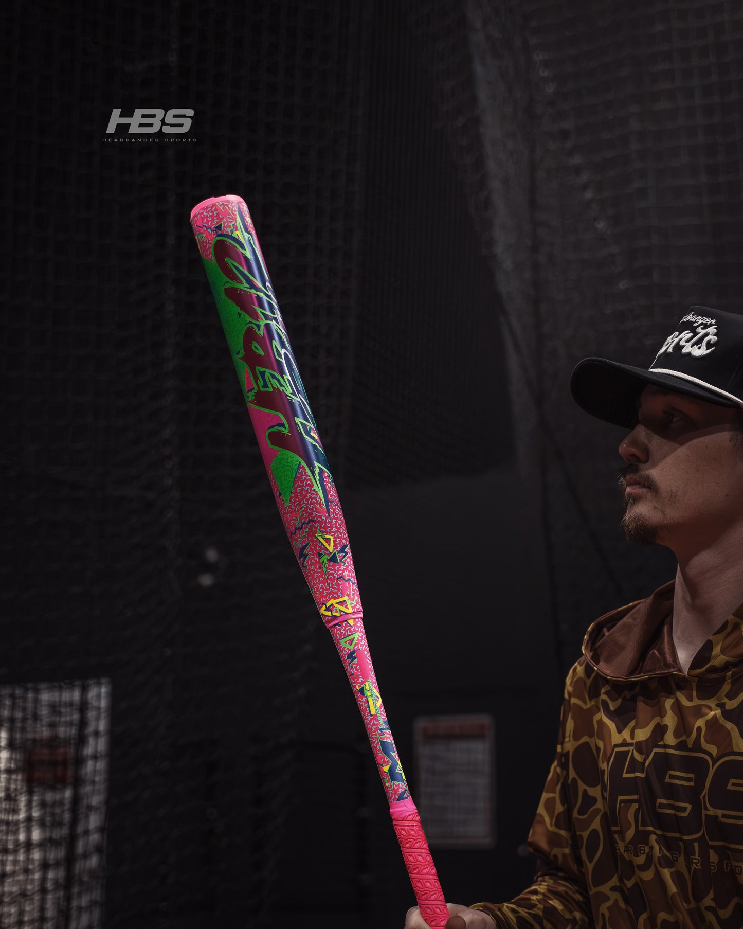 Softball player holding the 2026 Miken HB12 Retro 12.5" End Loaded USA / ASA Slowpitch Softball Bat in the batting cages at Headbanger Sports.