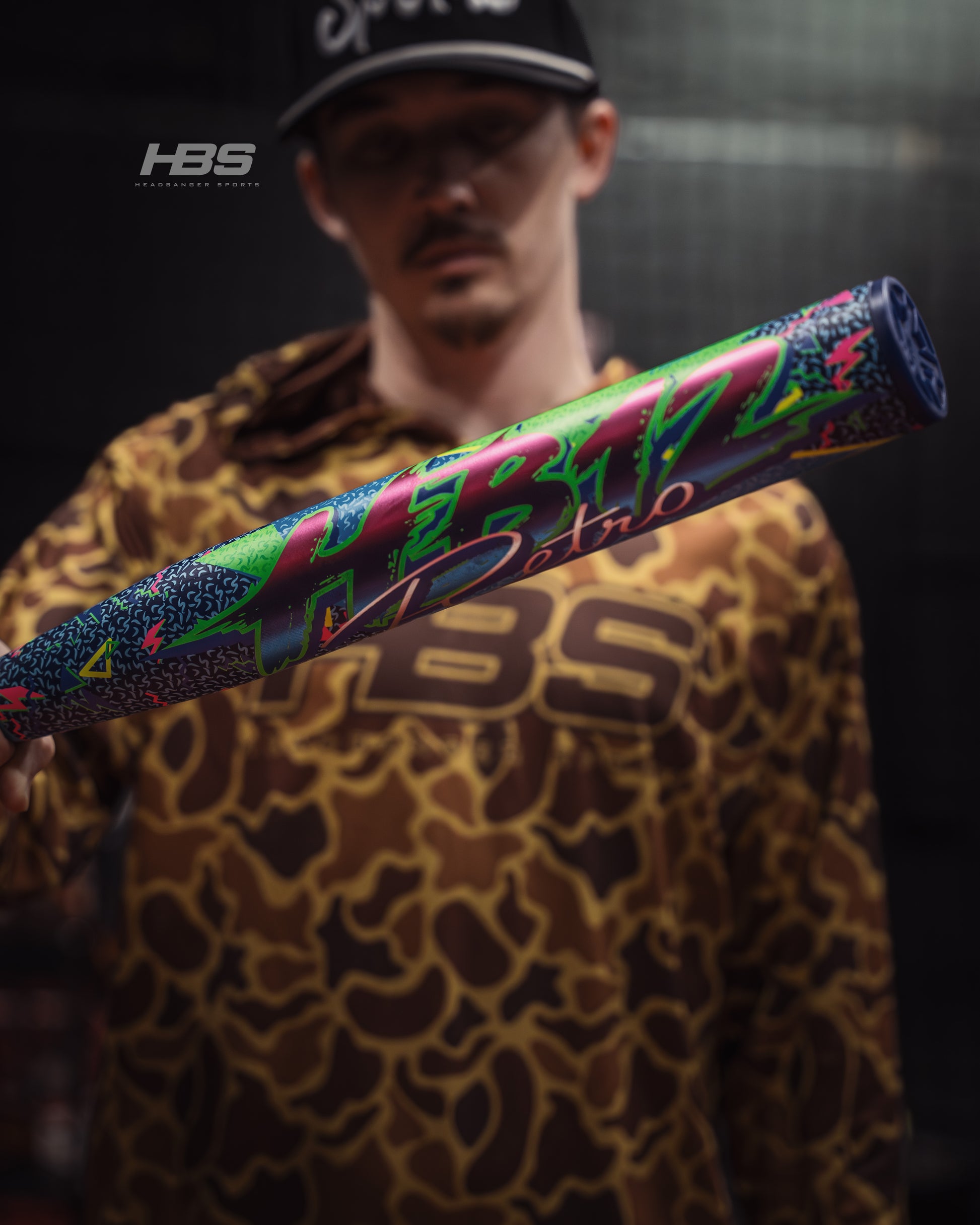 Softball player holding the 2026 Miken HB12 Retro 12.5" End Loaded USSSA Slowpitch Softball Bat in the batting cages at Headbanger Sports.