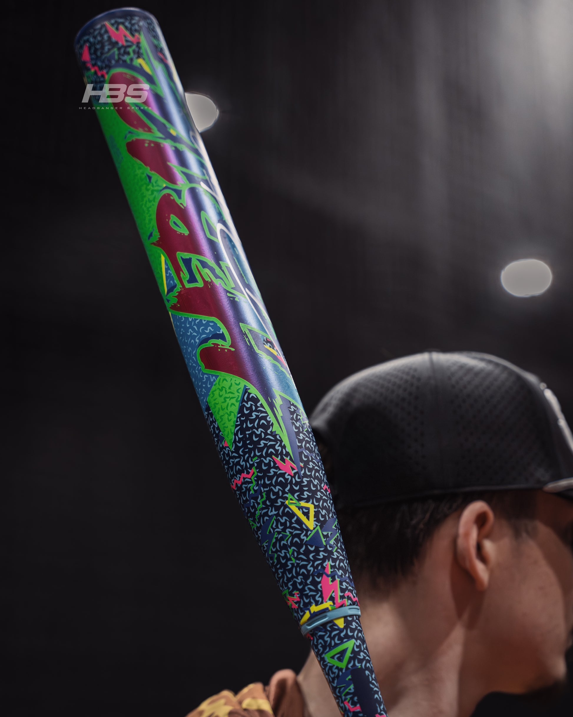 Softball player holding the 2026 Miken HB12 Retro 12.5" End Loaded USSSA Slowpitch Softball Bat in the batting cages at Headbanger Sports.