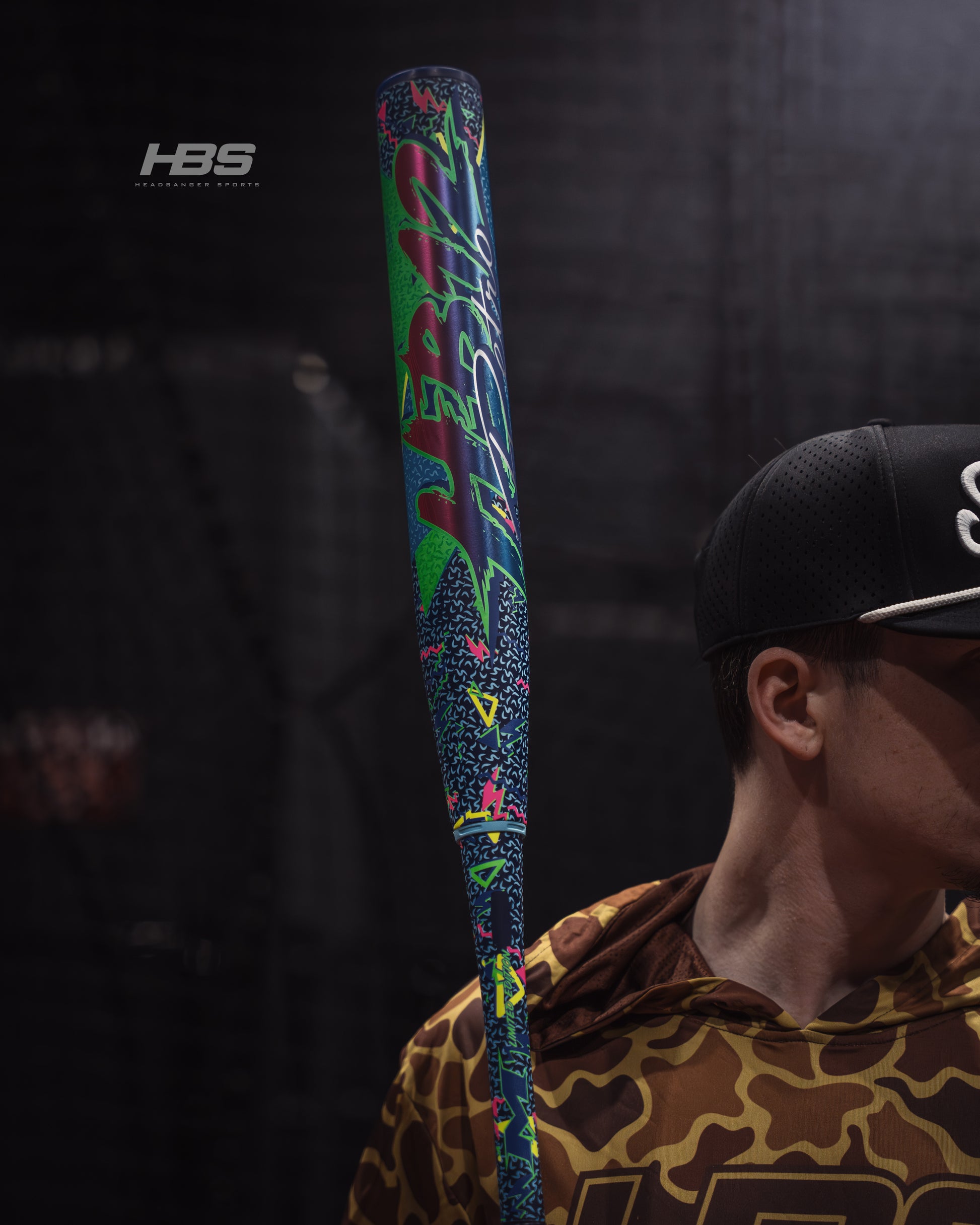 Softball player holding the 2026 Miken HB12 Retro 12.5" End Loaded USSSA Slowpitch Softball Bat in the batting cages at Headbanger Sports.