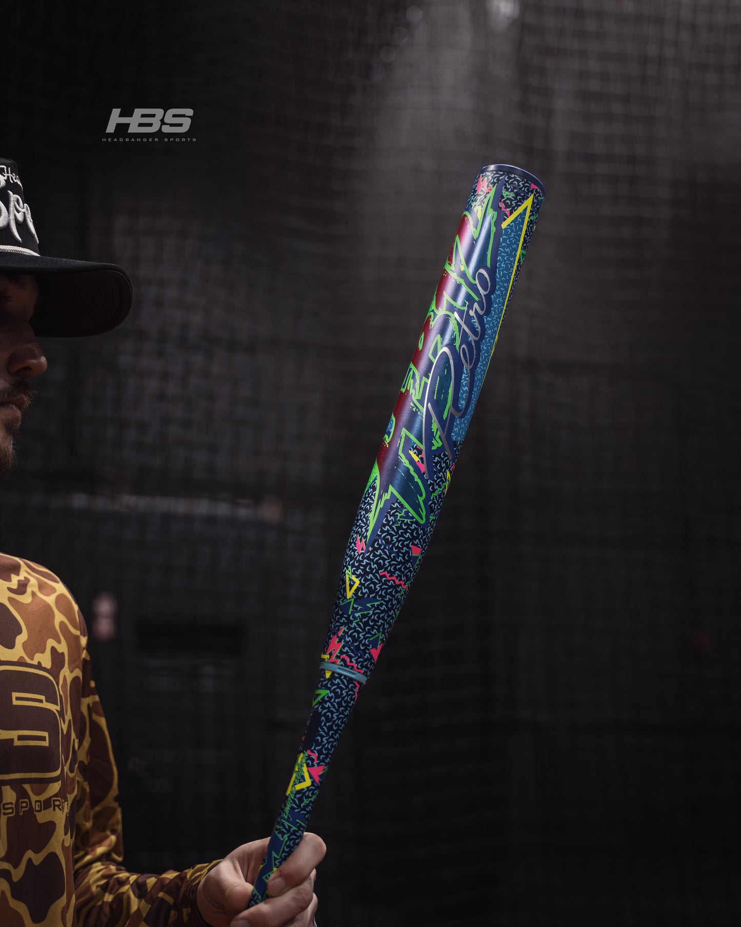 Softball player holding the 2026 Miken HB12 Retro 12.5" End Loaded USSSA Slowpitch Softball Bat in the batting cages at Headbanger Sports.