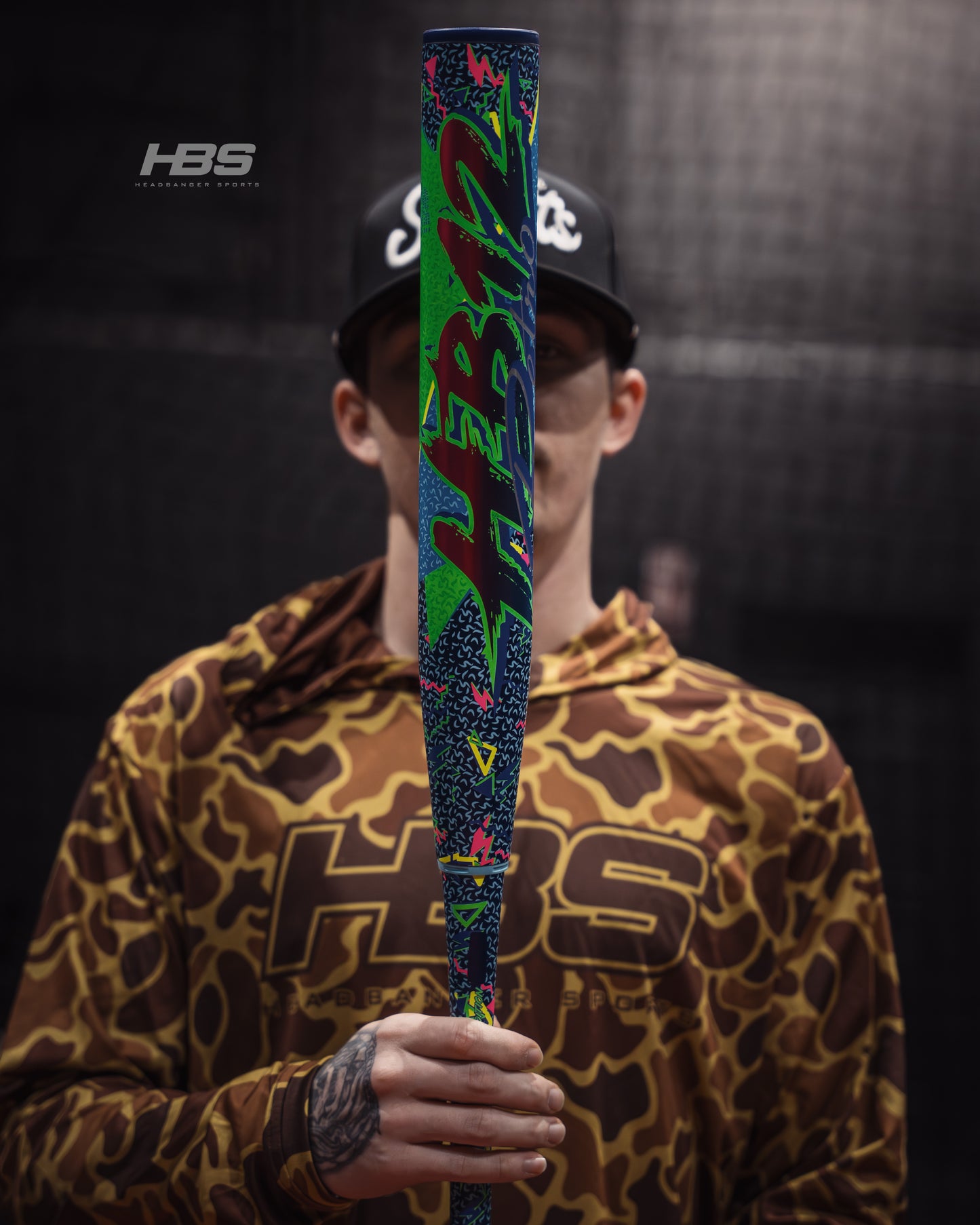 Softball player holding the 2026 Miken HB12 Retro 12.5" End Loaded USSSA Slowpitch Softball Bat in the batting cages at Headbanger Sports.