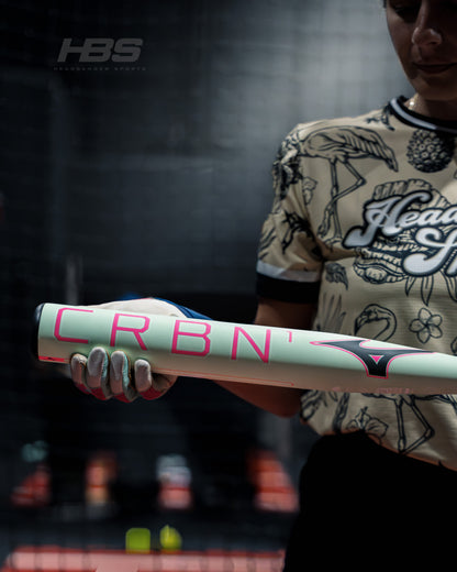 Softball Player holding the new 2026 Mizuno F25 CRBN1 Limited Edition Fastpitch Softball Bat in Mint and Pink at Headbanger Sports
