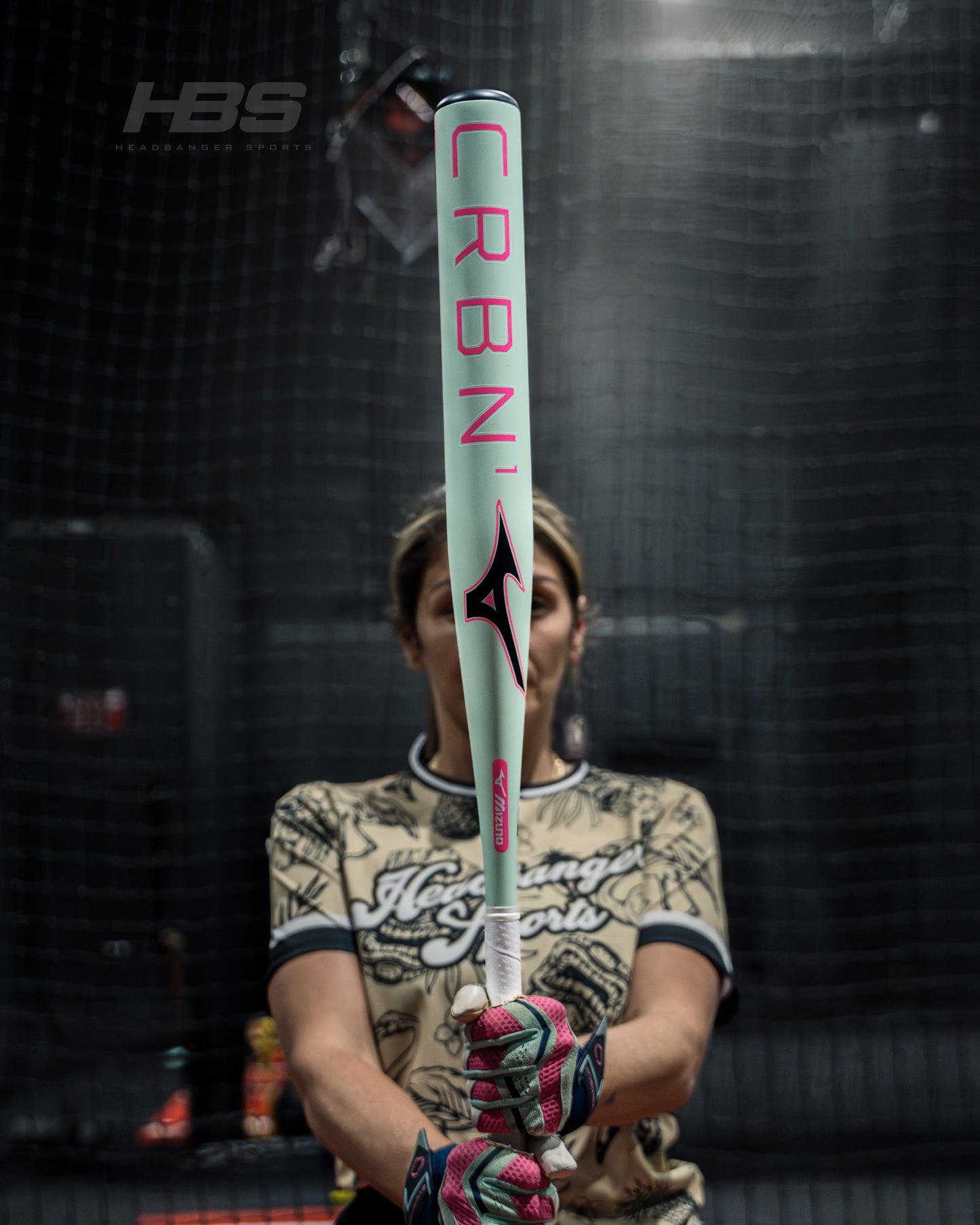 Softball Player holding the new 2026 Mizuno F25 CRBN1 Limited Edition Fastpitch Softball Bat in Mint and Pink at Headbanger Sports
