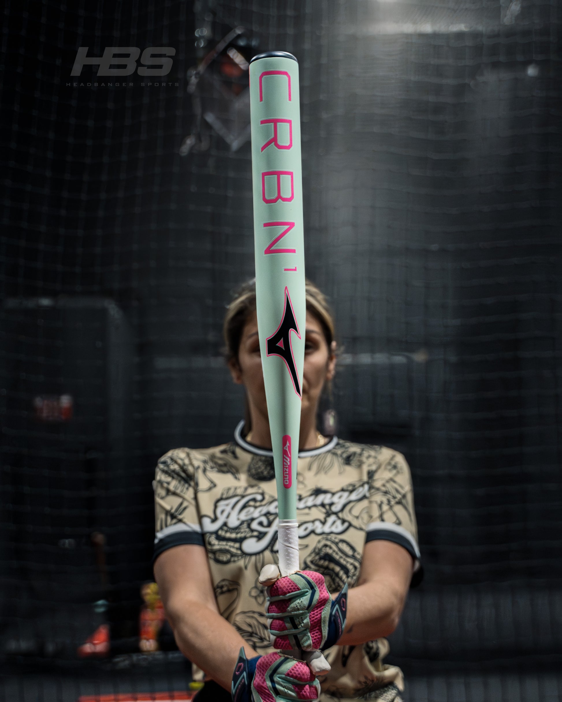 Softball Player holding the new 2026 Mizuno F25 CRBN1 Limited Edition Fastpitch Softball Bat in Mint and Pink at Headbanger Sports