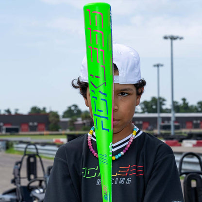 Marucci RCKLESS One PIece USA Baseball Bat being held by a baseball player at the racetrack