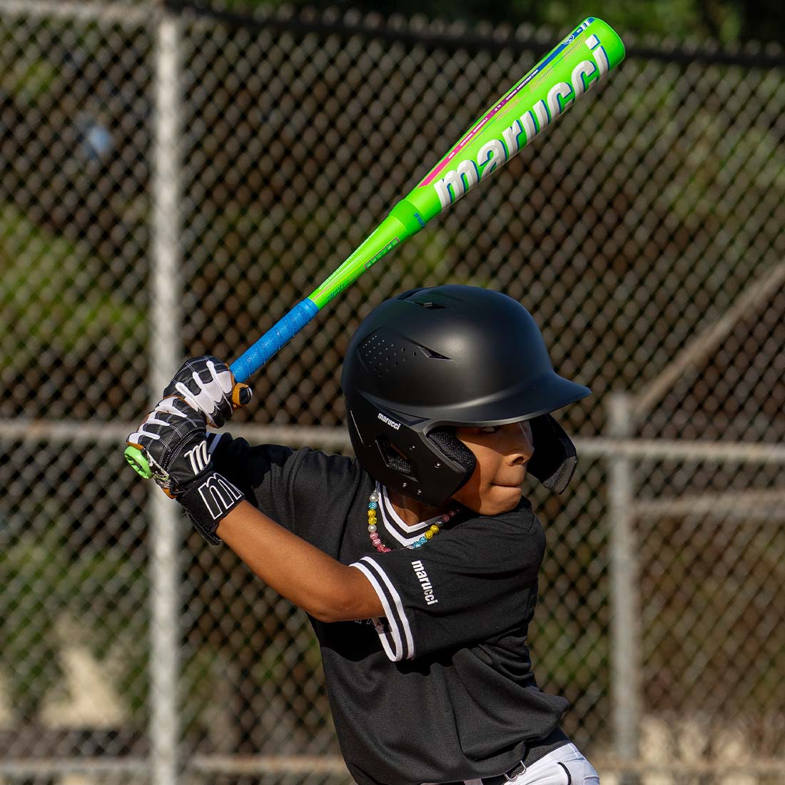 A young baseball player swinging the new Marucci RCKLESS Hybrid USA Baseball Bat