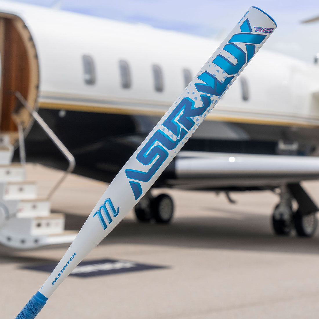 Marucci One Piece Asura LUX Rise Fastpitch Bat in front of a Jet on a tarmac