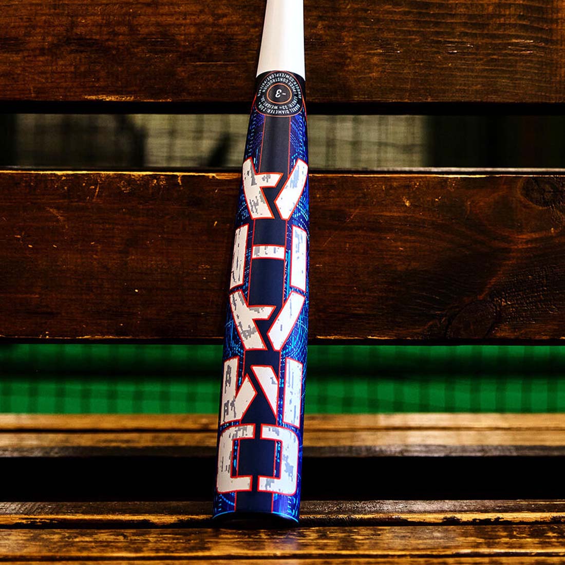 2027 Louisville Slugger Omaha BBCOR baseball bat end loaded one-piece alloy on a bench in a dugout
