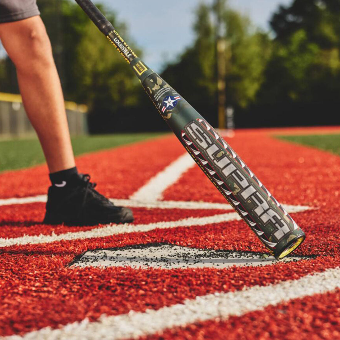 Louisville Slugger SUPRA LE Tigershark USSSA Baseball Bat on a baseball field turf