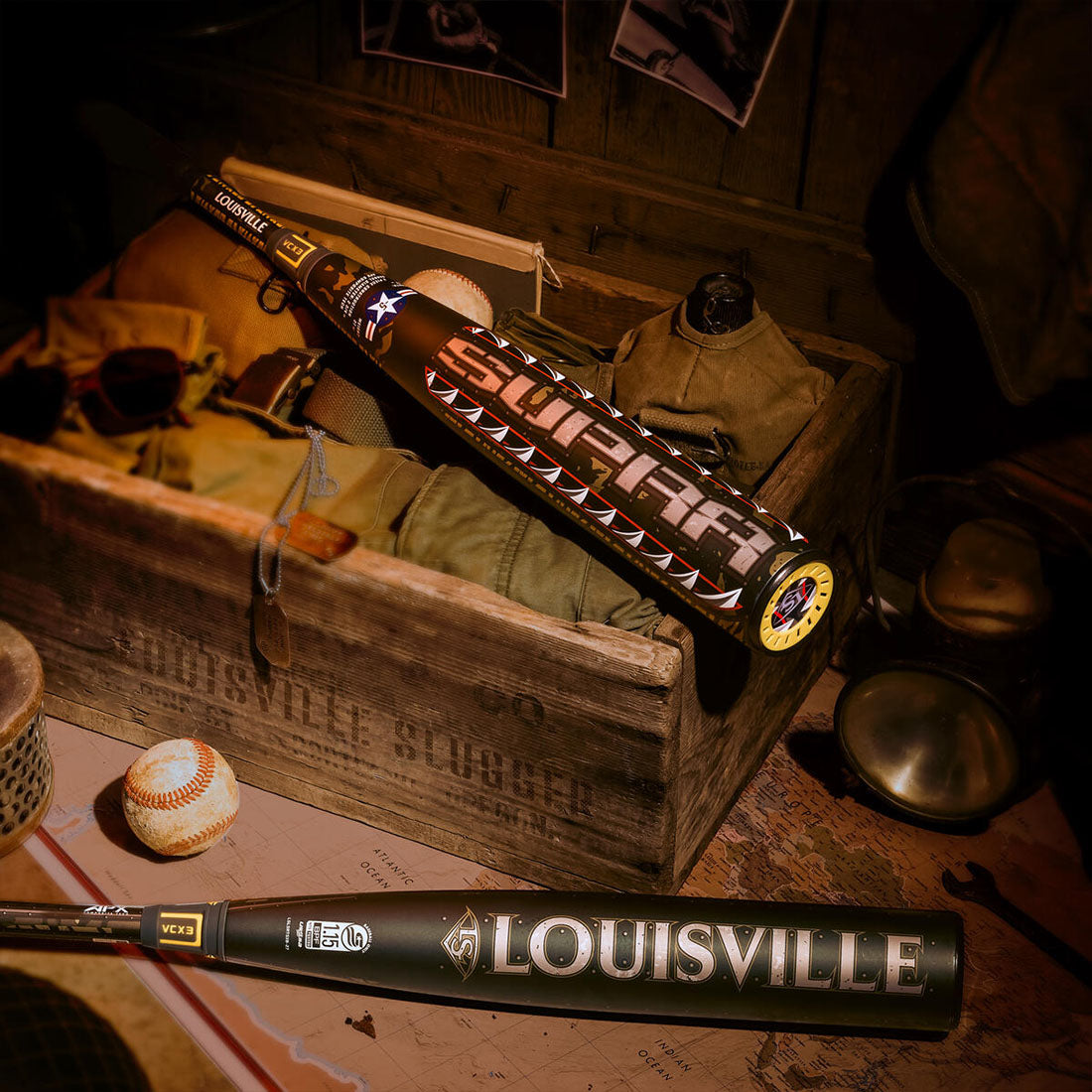 Louisville Slugger SUPRA LE Tigershark USSSA Baseball Bat laying in military gear