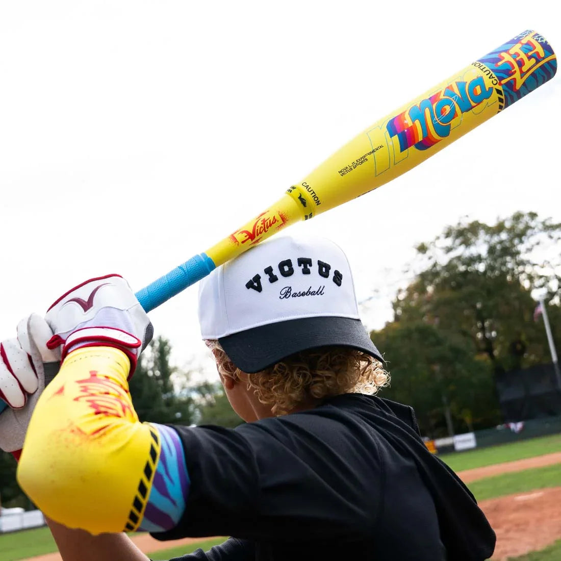 Player hitting with a Victus NOVA Lit USSSA baseball bat with XL barrel, two-piece composite, 2SIX connection and Carbon Eclipse composite construction