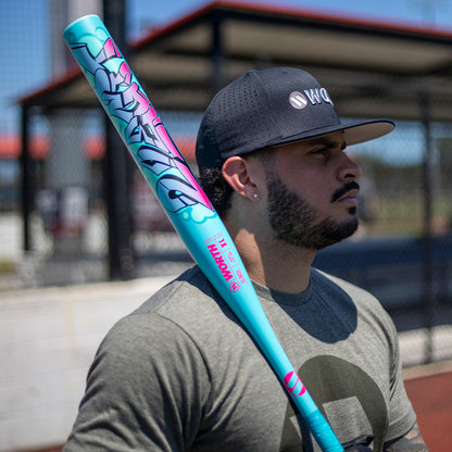 Slowpitch player holding the 2026 Worth 2 Legit 13" 1PC XL End Loaded USSSA Slowpitch Softball Bat at Space Coast Fields