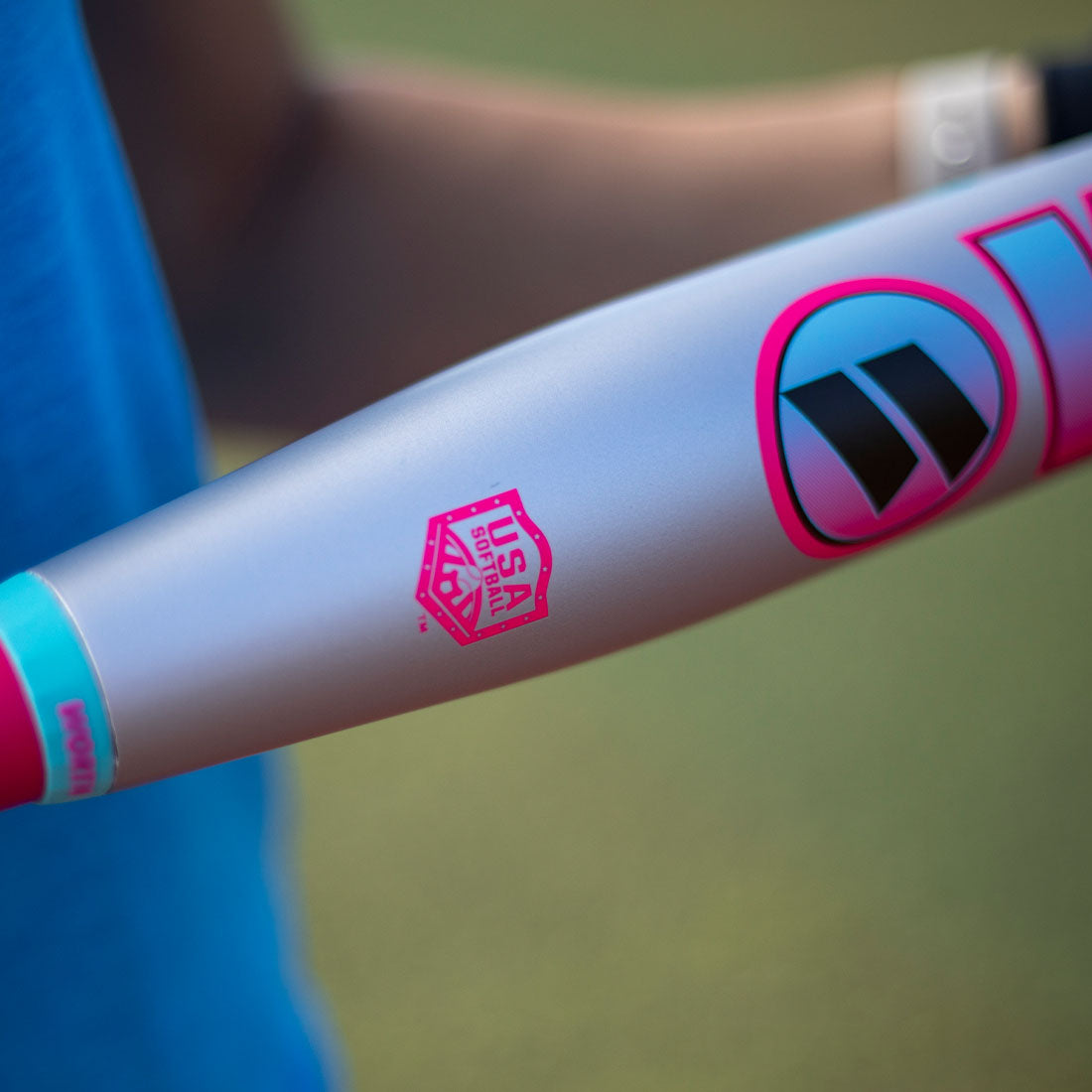A slowpitch softball players holding the new Worth 2 Legit XL USA slowpitch bat  on a ball field