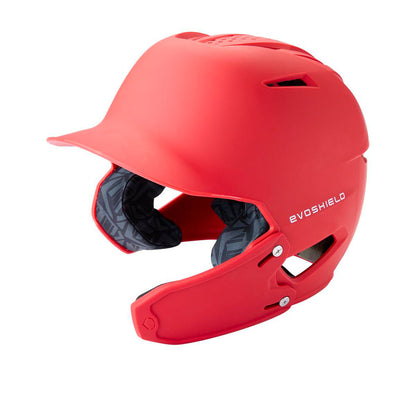A matte red EVOSHIELD baseball helmet with a built-in face guard and dark gray interior padding, shown from a three-quarters angle on a white background.